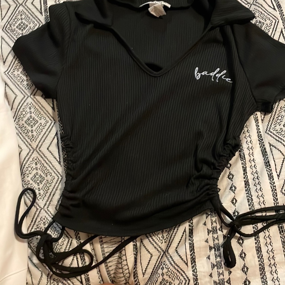 Black shirt with caller on top with strings on side